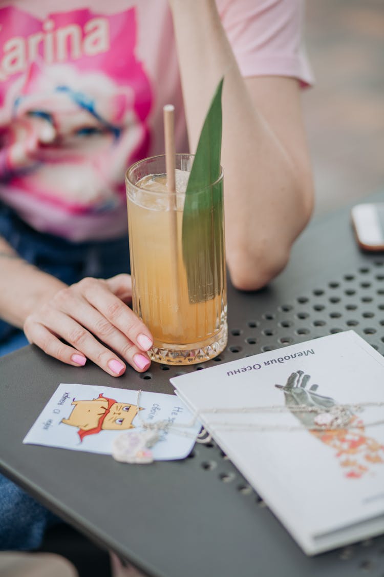 A Person Sitting With A Drink