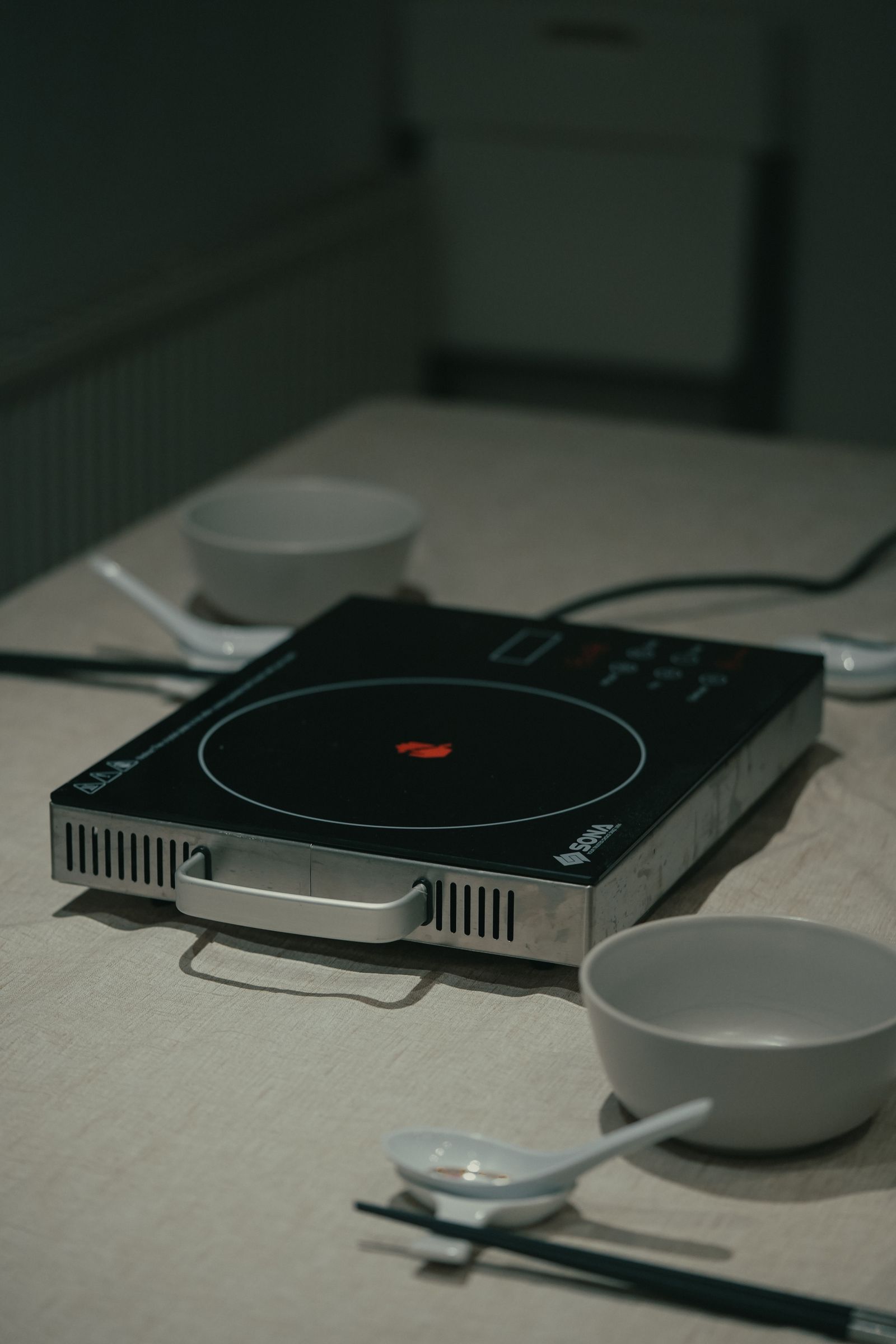 Indoor table with induction cooker set up for Chinese hot pot meal