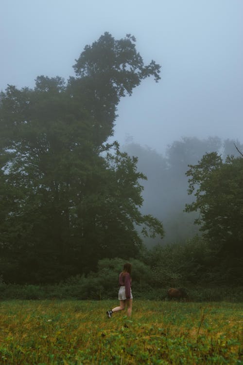 Woman Walking on Grassland in Countryside