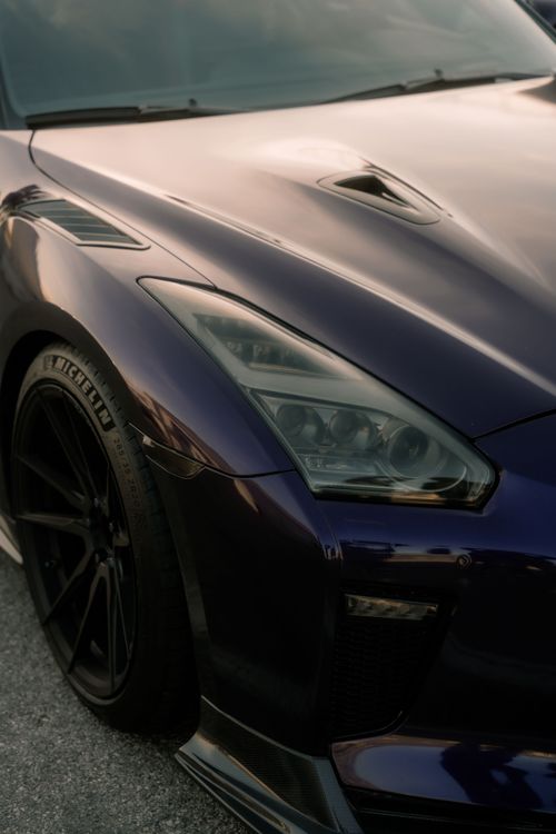 Free Close-up of a sleek purple sports car with custom modifications. Captured in Cremona, Italy. Stock Photo