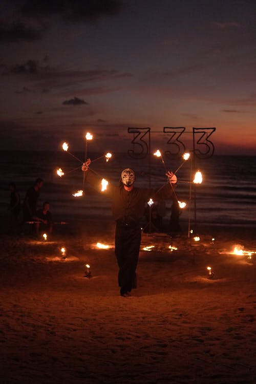 Man Performing with Fire on a Beach 