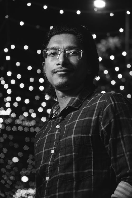 Free Stylish portrait of a man with eyeglasses, illuminated by soft bokeh lighting. Stock Photo