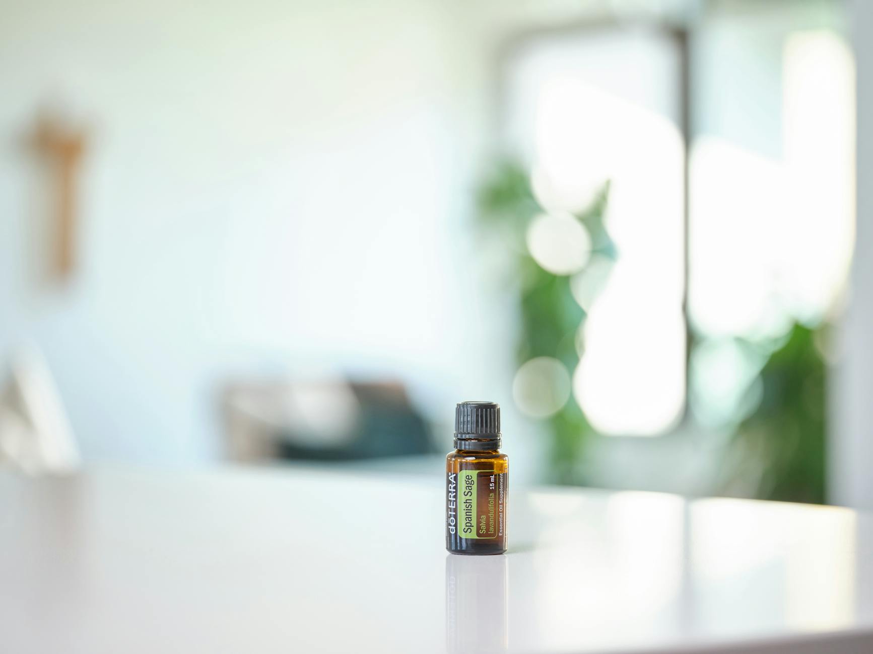A bottle of essential oil sitting on a table