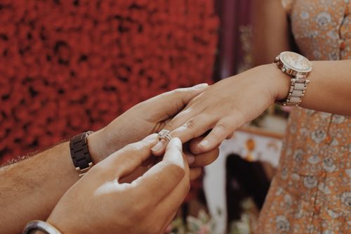 Free Close-up of hands during a ring exchange ceremony in India, symbolizing love and commitment. Stock Photo