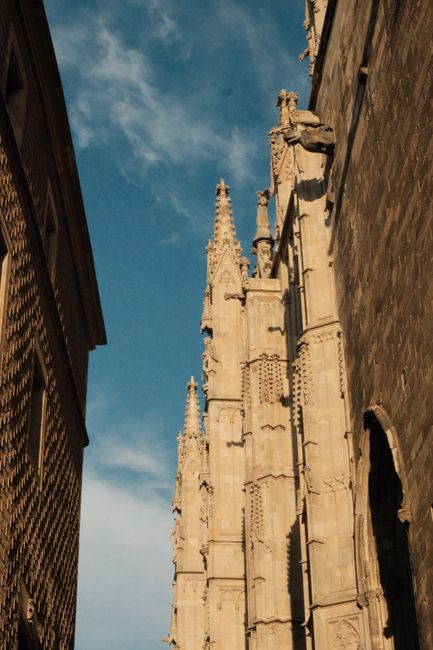 Stunning view of Gothic cathedral spires in Barcelona against a clear blue sky.