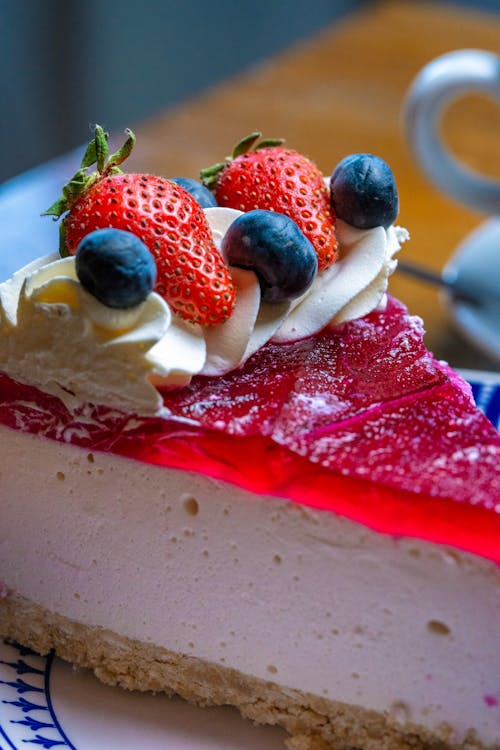 Close-up of a Slice of Cheesecake with Jelly and Fruit on Top 