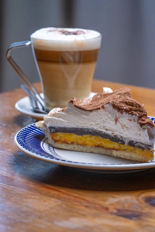 Free A Cup of Coffee and a Slice of Cake on a Plate  Stock Photo