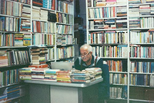 Elderly Man Sitting in Library