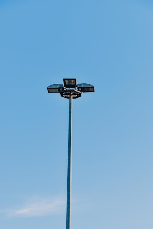 Halogen Lamps on a Tall Lamppost With Blue Sky in the Background