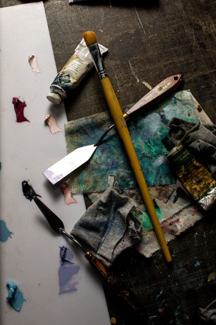 A collection of art tools on a rustic table in Baku, Azerbaijan.
