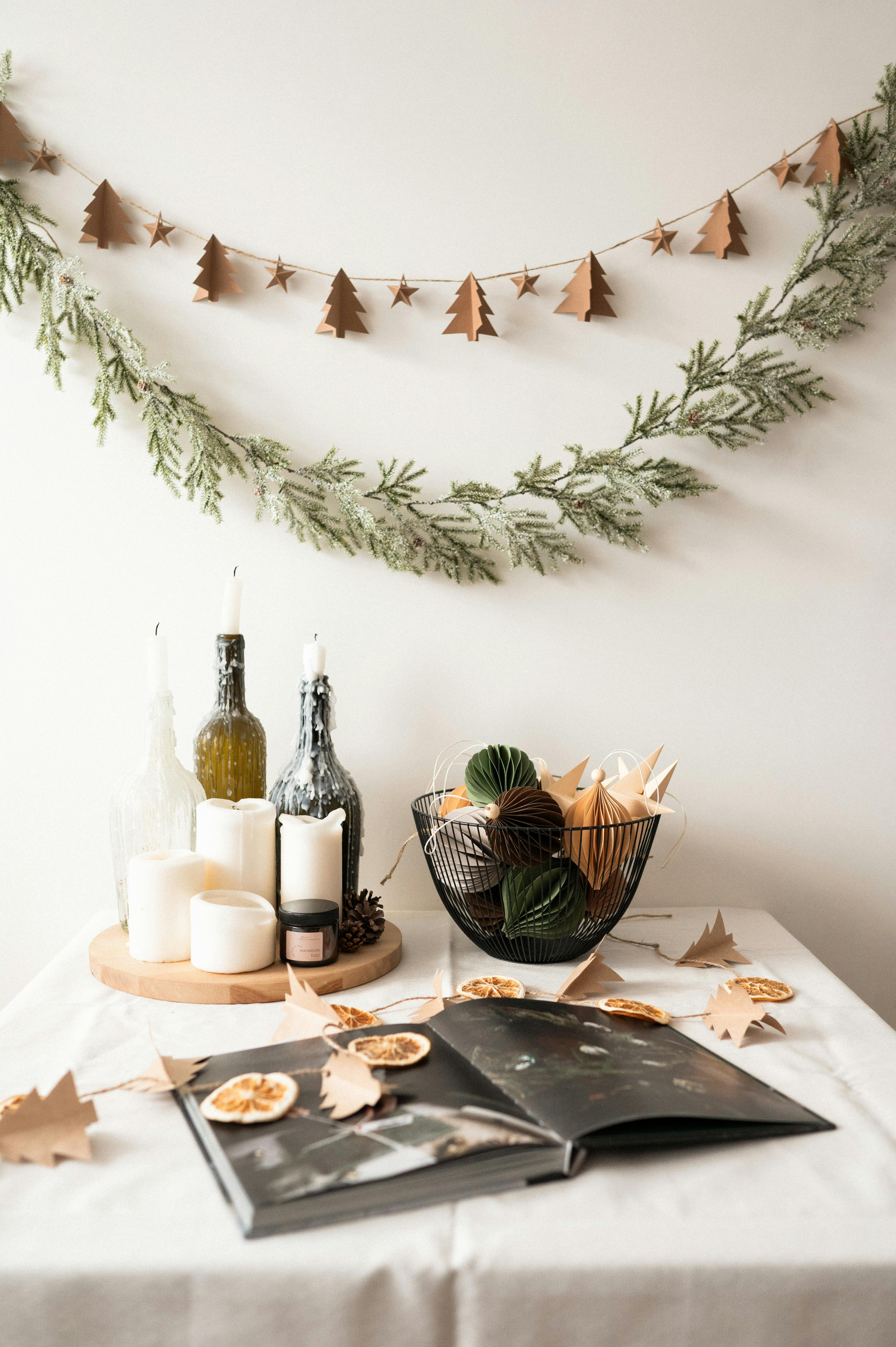 Warm indoor table setting featuring candles, decorative bottles, and autumnal decor, perfect for cozy seasonal inspiration.