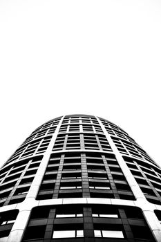 Low angle shot of a modern skyscraper in Bratislava, Slovakia, showcasing urban architecture in black and white.