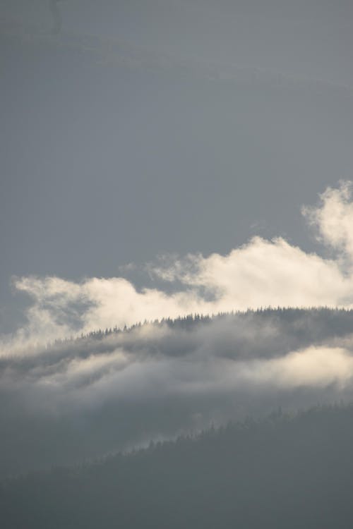 View of Mountains under a Blue Sky and White Clouds 