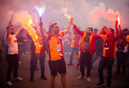 Free Excited soccer fans light flares in a vibrant street celebration in Istanbul, Turkey. Stock Photo