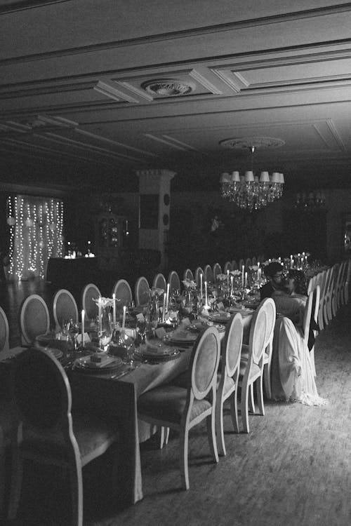 Kissing Bride and Groom Sitting at Table