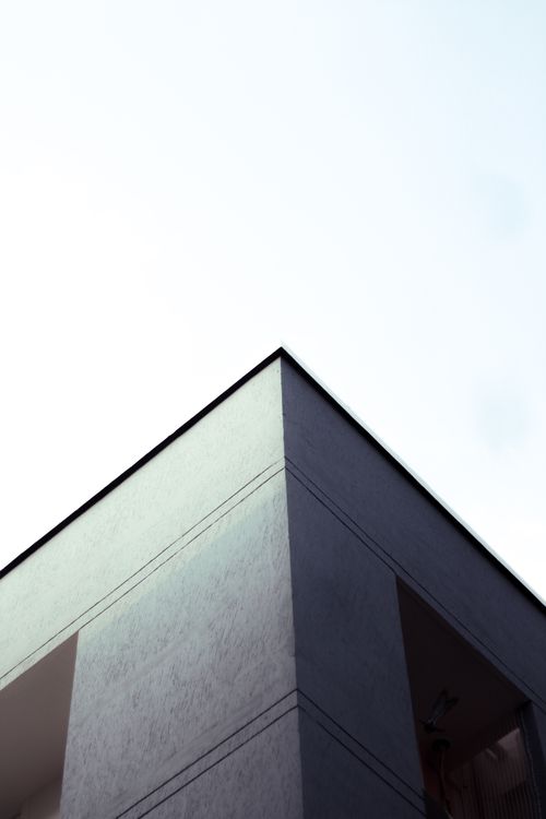 Free Minimalist architectural photo showing a modern building facade against a clear sky. Stock Photo