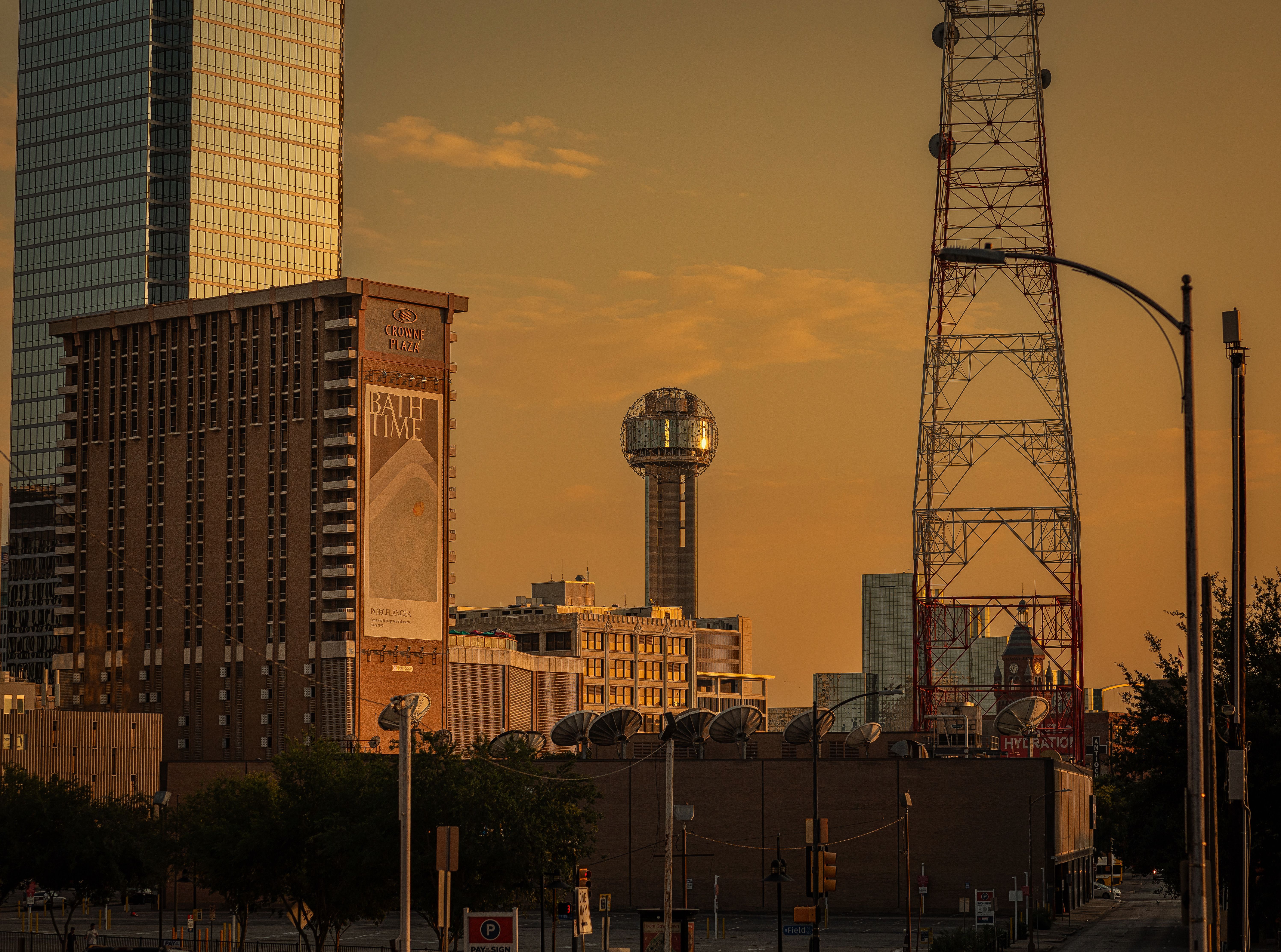 Dallas skyline showcasing weather variations with clouds and sunlight highlighting the cityscape in Texas