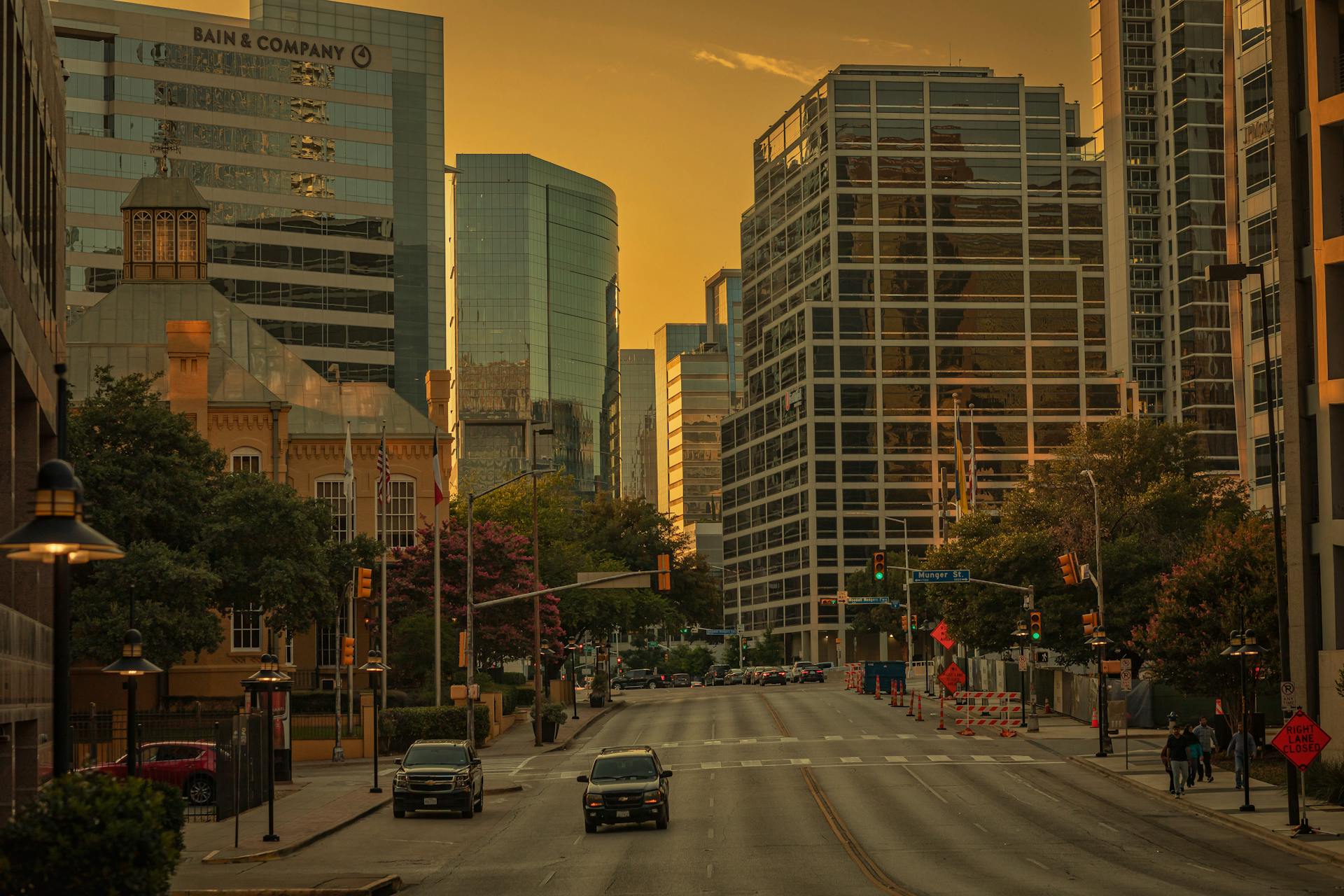 A vibrant cityscape showcasing modern architecture in downtown Dallas during golden hour.