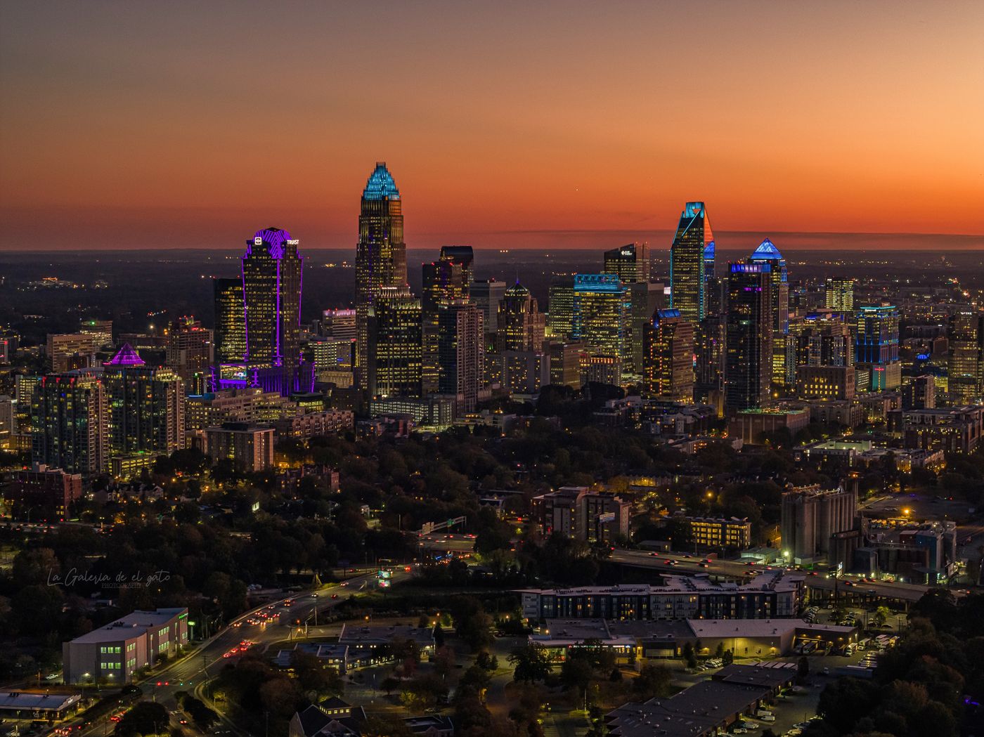 Aerial view of the Charlotte metro area with illuminated buildings at twilight