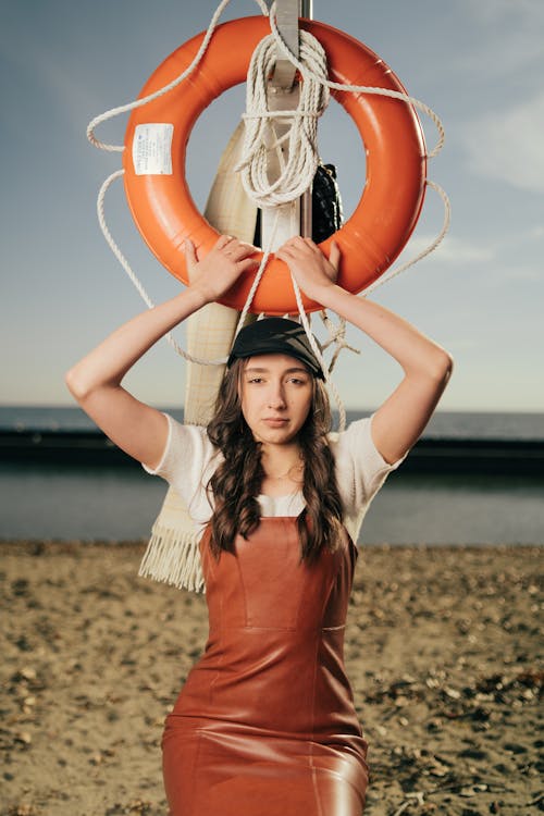 A woman in a leather dress holding a life preserver