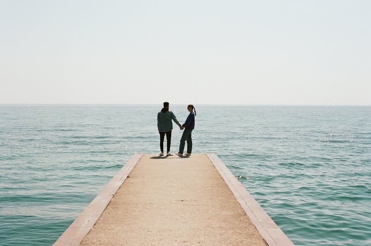 Romantic Couple On Pier In Sea