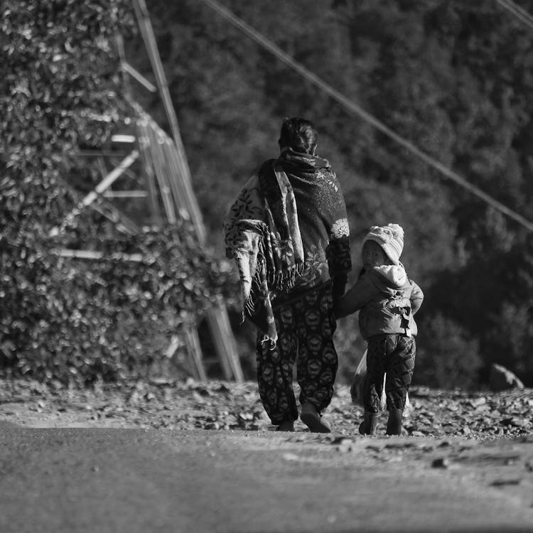 Mother And Daughter On Dirt Road In Black And White