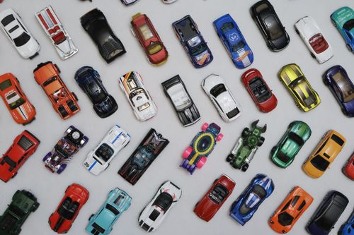 Free A vibrant assortment of toy cars arranged on a white background, viewed from above. Stock Photo