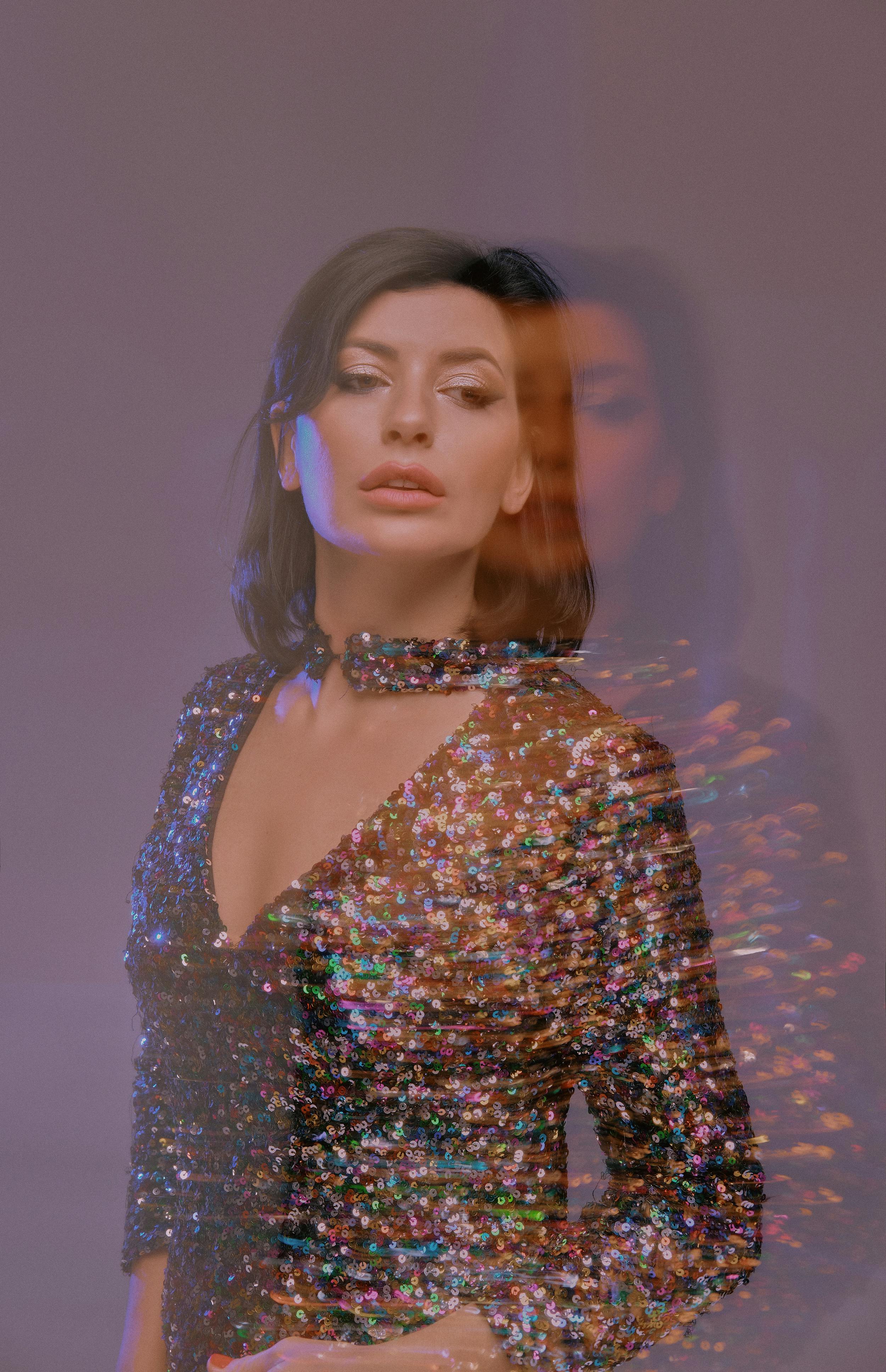 Elegant double exposure of a model in a sequin outfit, creating an artistic visual effect.