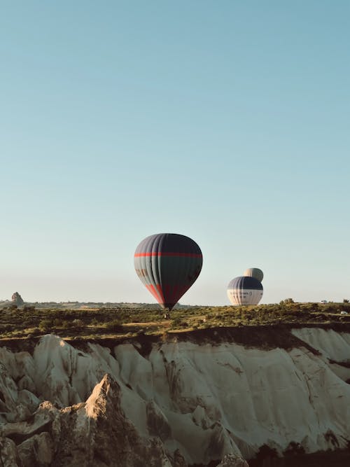 Free Hot Air Balloons Flying over Mountains  Stock Photo