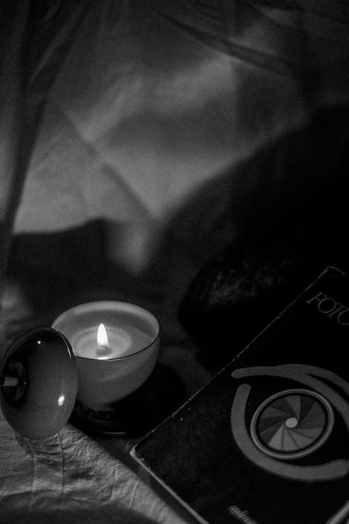 Black and White Photo of a Book and a Candle 