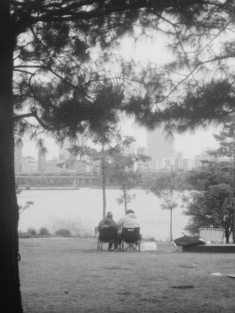 People In Folding Chairs By River