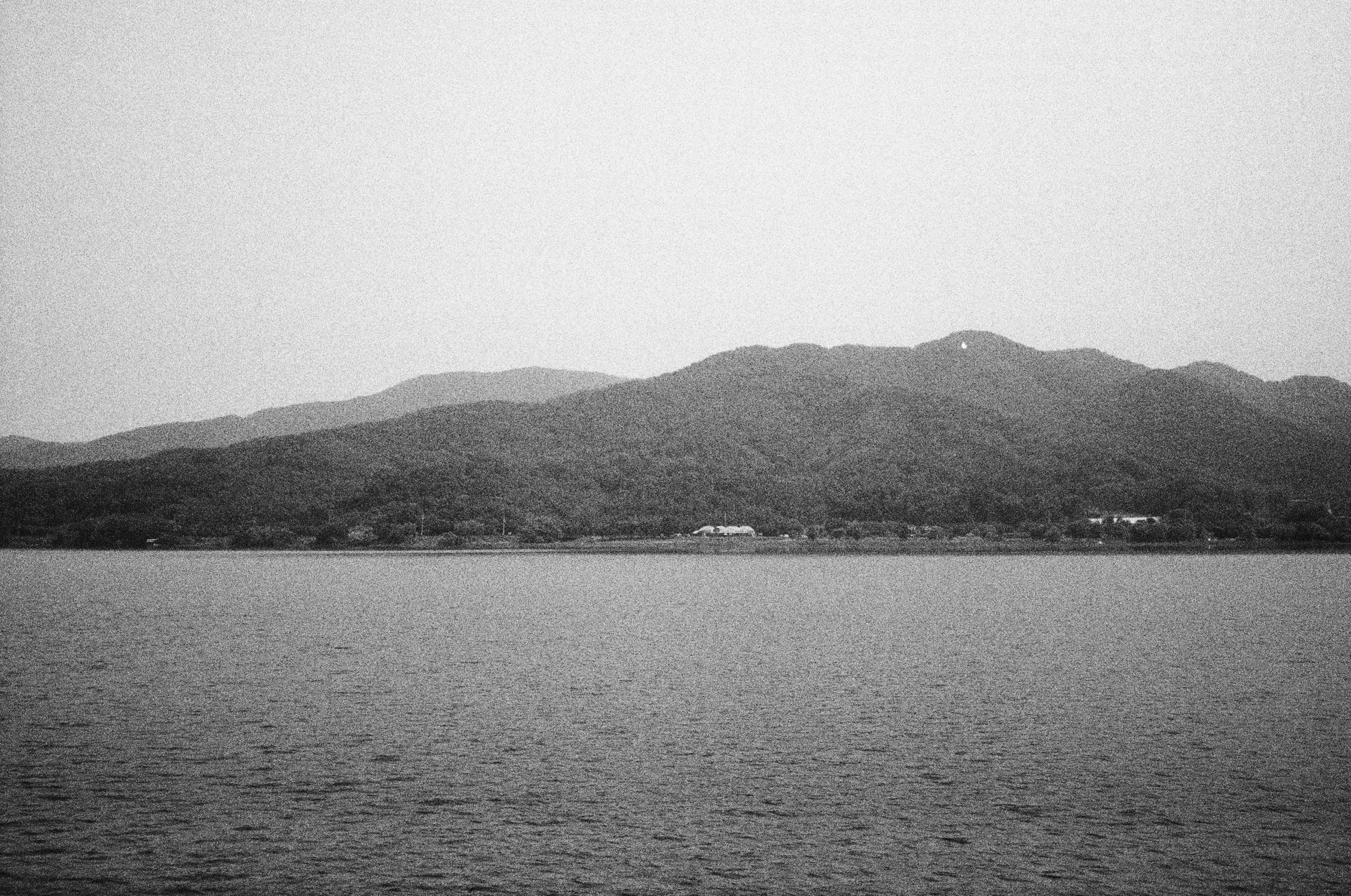Monochrome view of serene lake and hills in Seoul, South Korea.