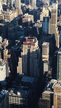 Aerial view of New Yorker Hotel amidst Manhattan skyscrapers, capturing the vibrant urban landscape.