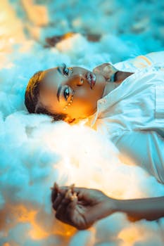 Captivating portrait of a woman lying in fluffy clouds with elegant lighting.