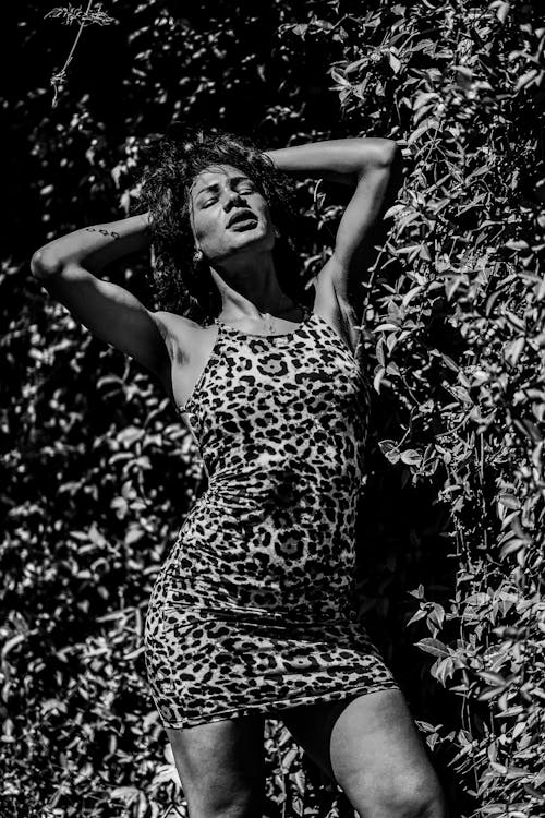 Young Woman in a Cheetah Print Dress Posing Outside 