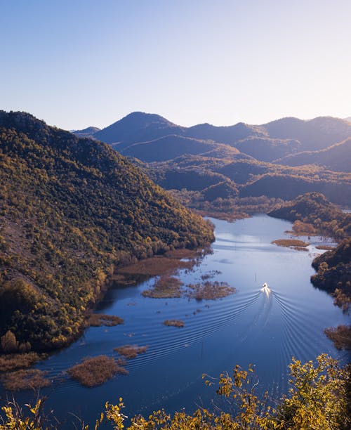 Free Aerial View of a Body of Water in a Mountain Valley  Stock Photo