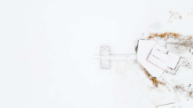 A serene aerial winter shot capturing snow-covered structures and landscape in Tödürge, Sivas, Türkiye.