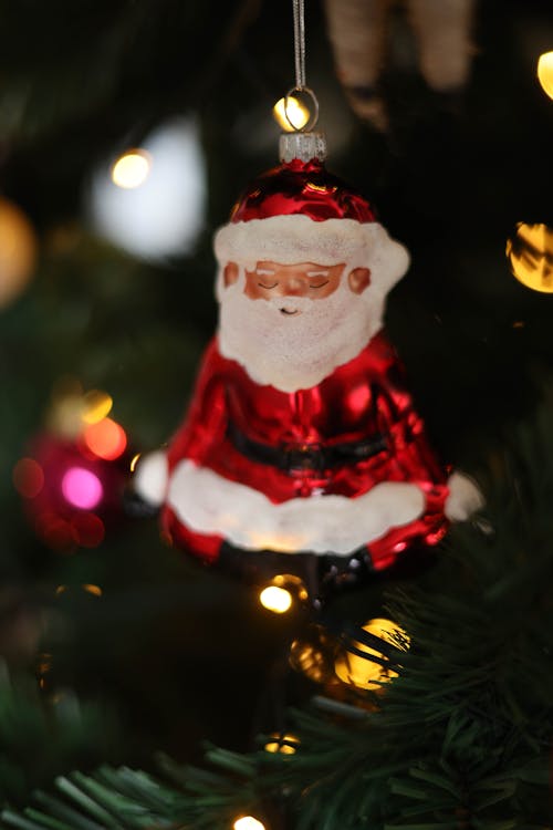 Close-up of a Christmas Ornament in the Shape of a Santa Claus Hanging on a Tree