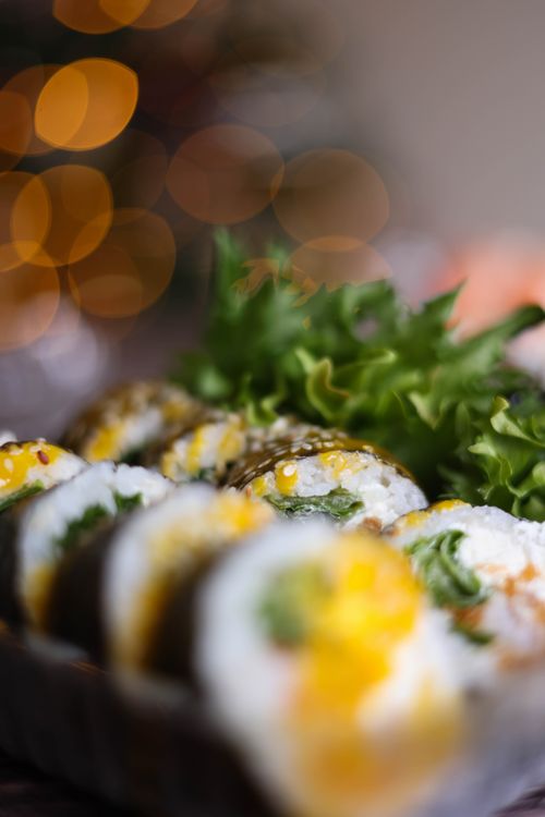 Free Delicious sushi rolls with bright ingredients and lettuce, captured in an artistic close-up. Stock Photo
