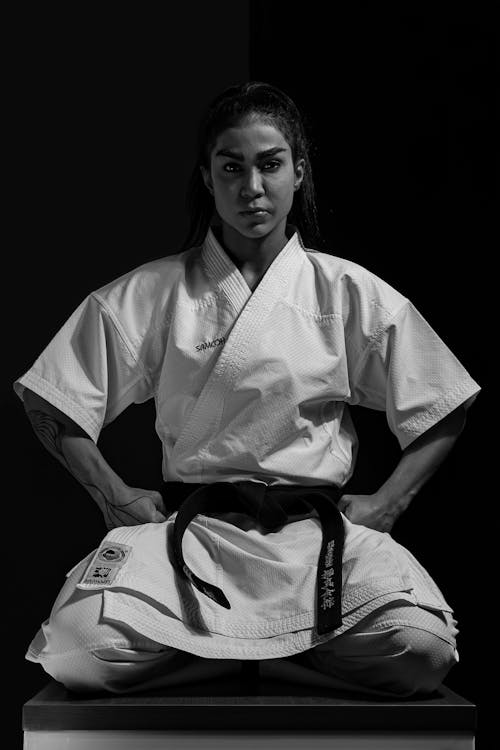 Martial Artist Crouching in Front of Black Background