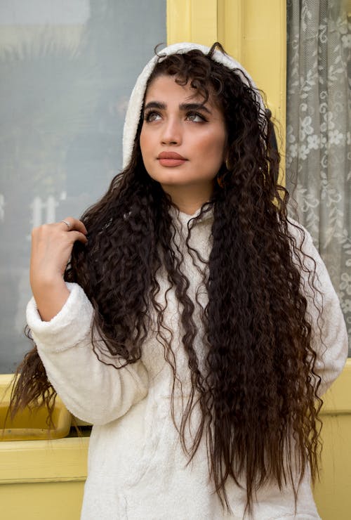 Young Woman with Long Brown Hair Standing Outside 