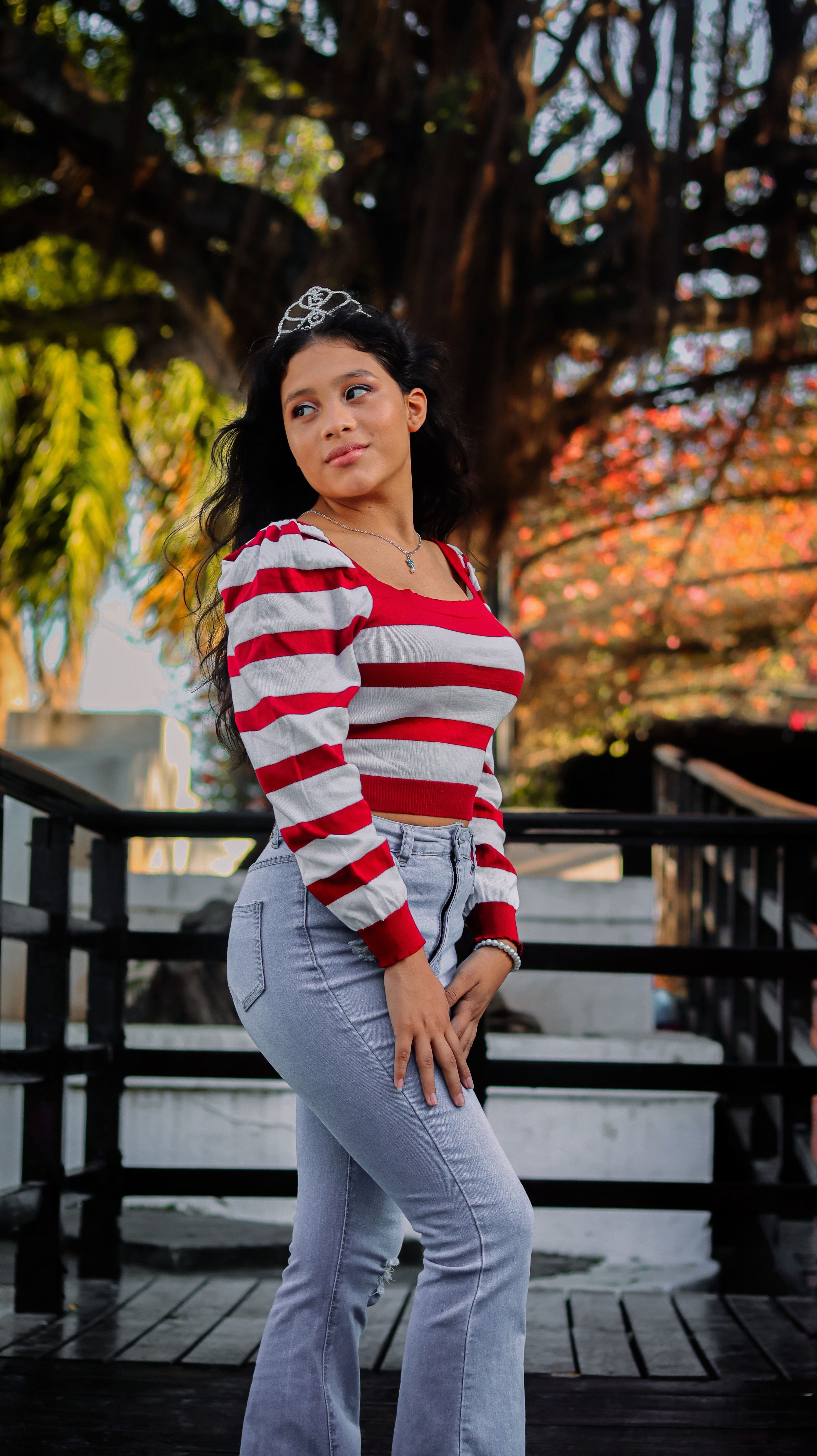 Woman Posing in Jeans, a Striped Blouse and a Tiara · Free Stock Photo
