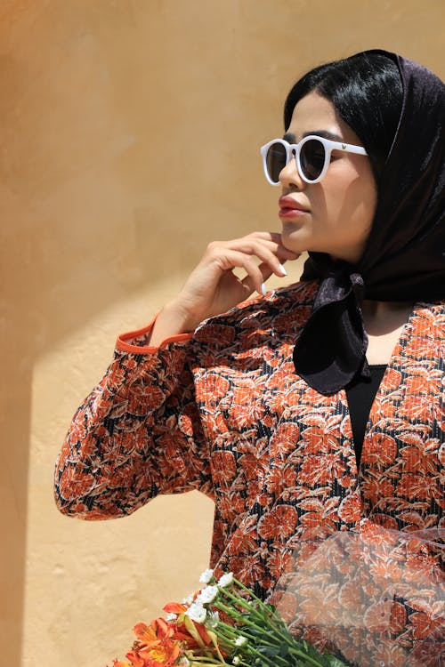 Young Woman in a Headscarf and Sunglasses Standing Outside in Sunlight 