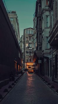 Charming cobblestone street in Istanbul with glowing streetlights at dusk, capturing urban allure.