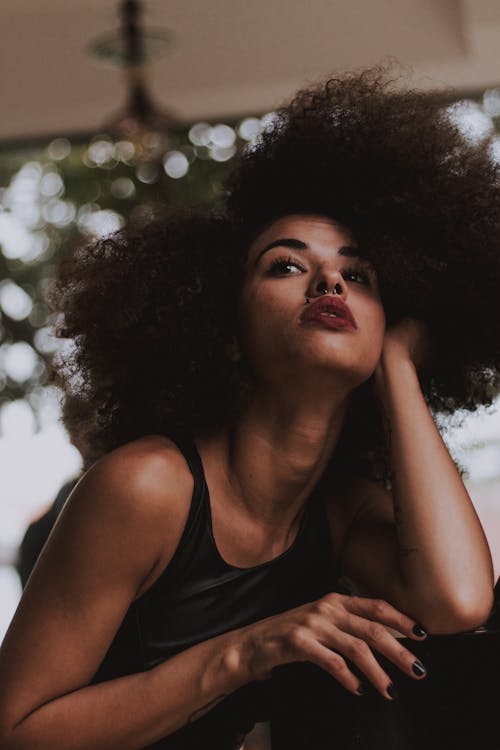 Free Low Angle Shot of Woman Posing While Holding Her Hair Stock Photo