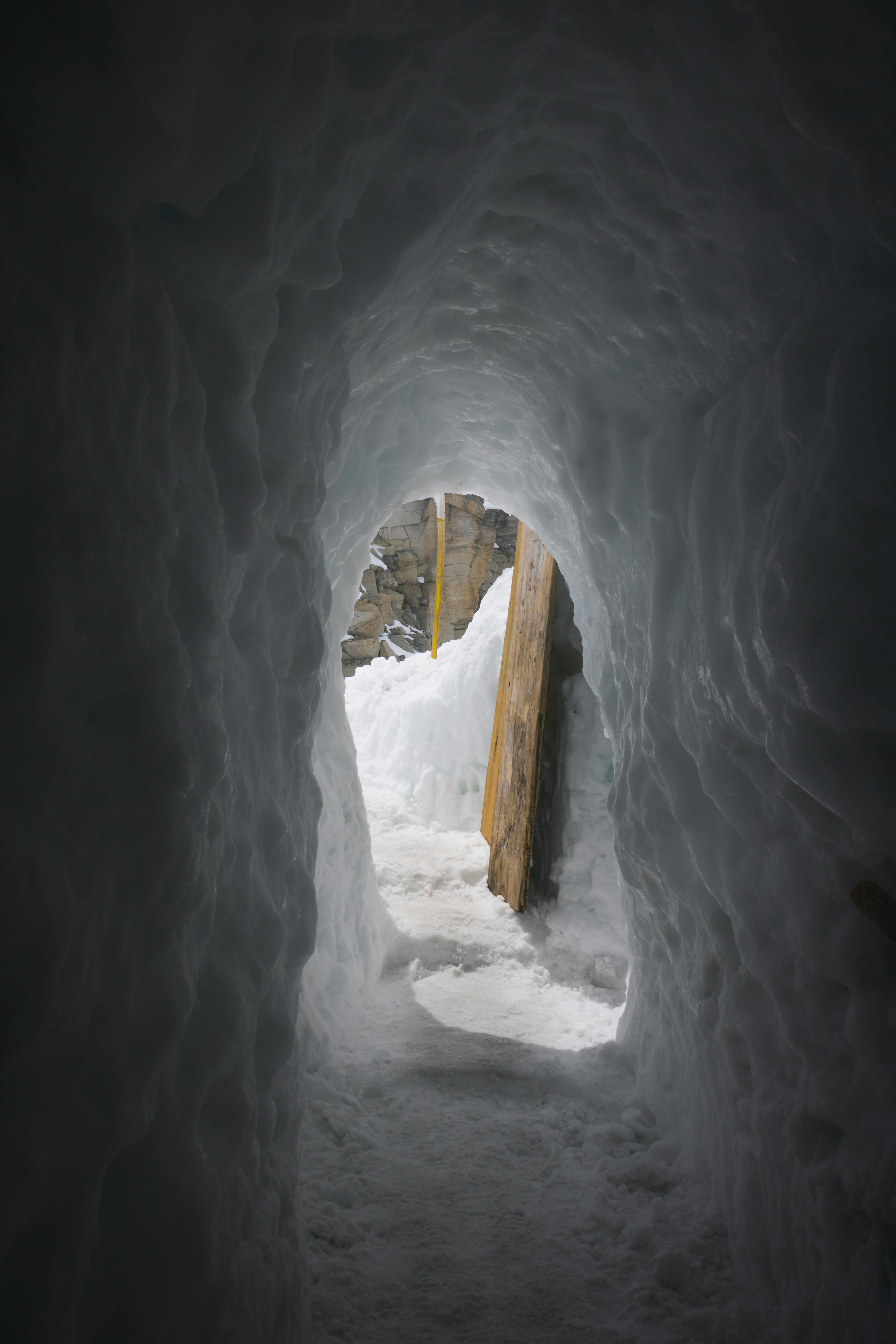 a tunnel in the snow with a door in it