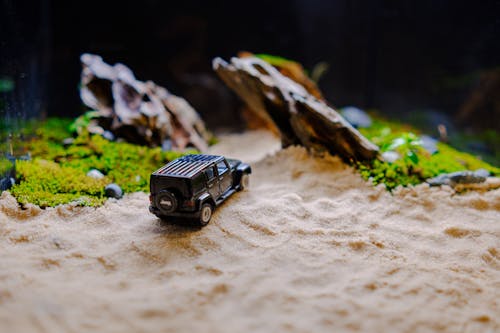 Model with Miniature Jeep on Sand