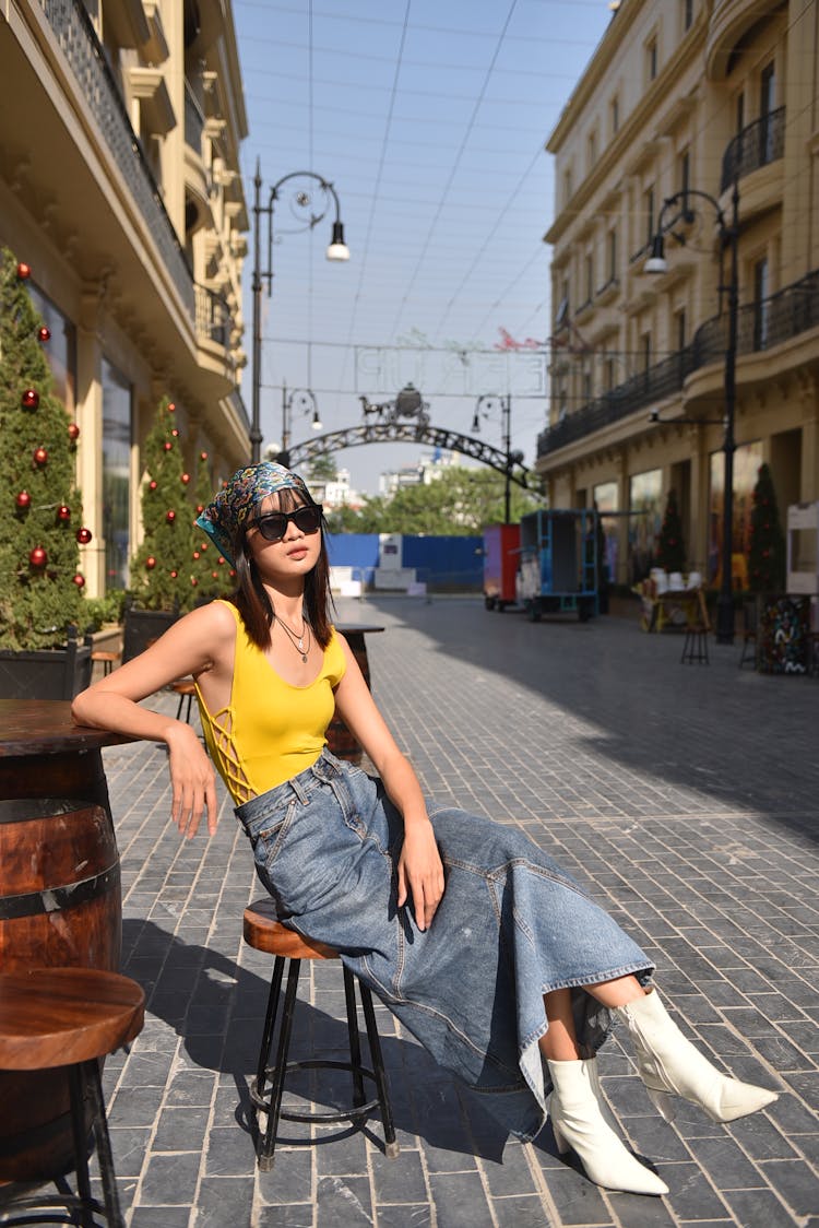 Model In Yellow Bodysuit And Long Denim Skirt