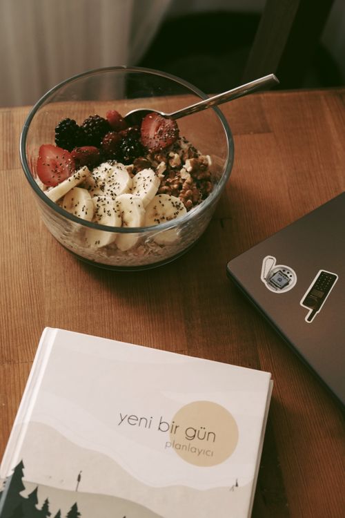 Free Bowl of homemade granola with fresh fruits and oat flakes on wooden table. Stock Photo