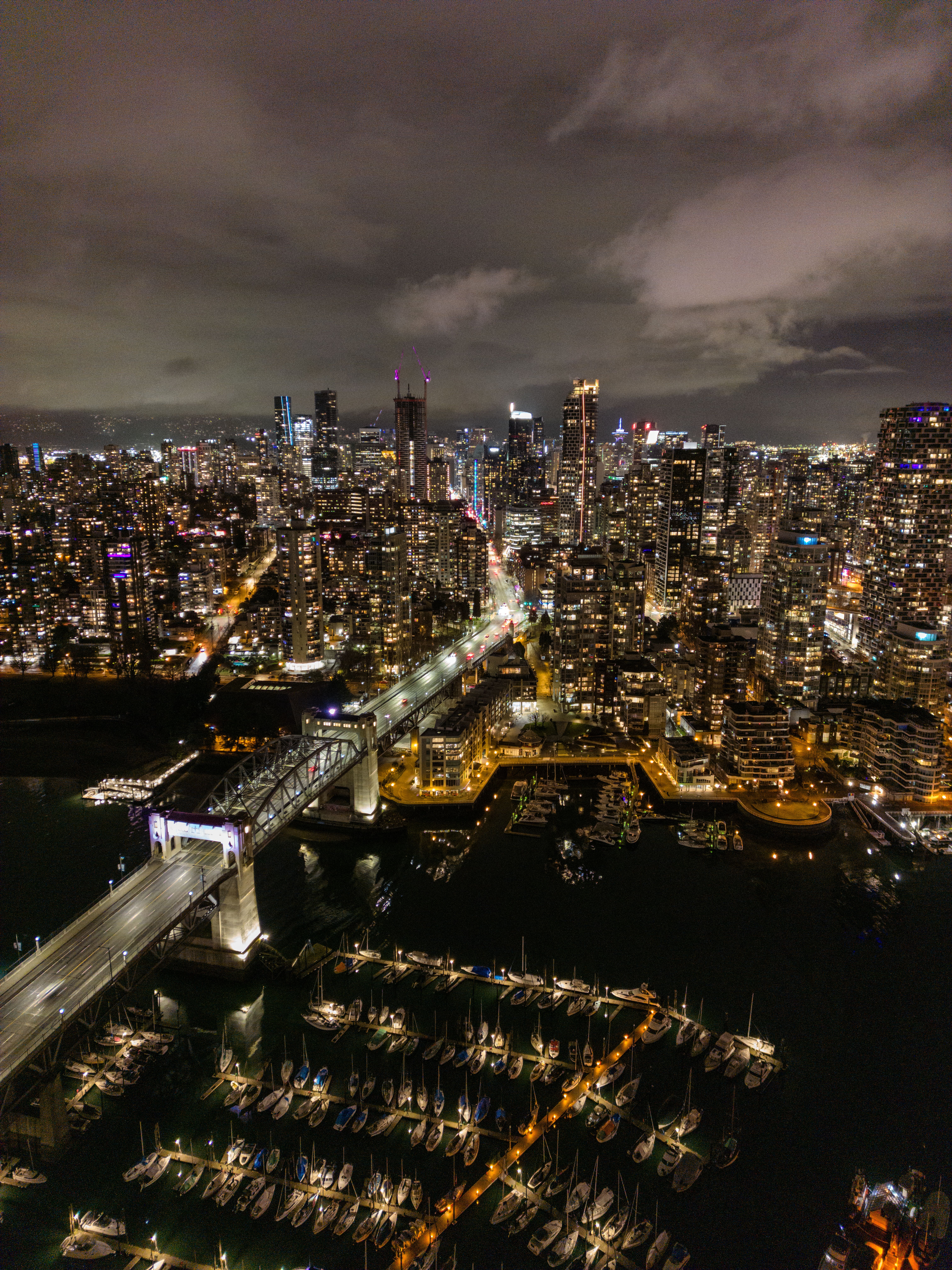 Stunning aerial night view of Vancouver's illuminated skyline and marina.